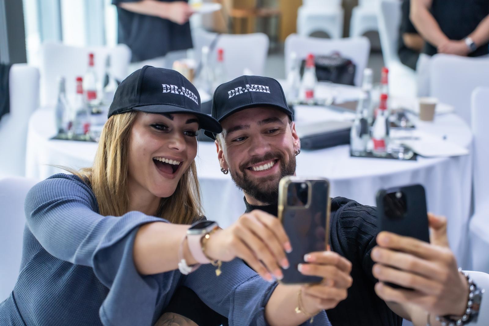Attendees taking a selfie in Dr Azri caps